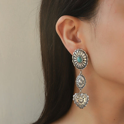 Close-up of an ear wearing a silver earring with a heart design.